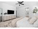 Stylish bedroom offers ample space, a modern dresser, and an ensuite bathroom for convenient living at 9230 E Scott Ave, Mesa, AZ 85212