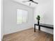 Bright office space with hardwood floors, large window, and a sleek black desk at 9230 E Scott Ave, Mesa, AZ 85212