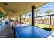 Outdoor patio area with ceiling fans, ping pong table, views of palm trees and lawn at 9230 E Scott Ave, Mesa, AZ 85212