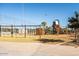 Community playground featuring modern climbing structures, swings, slides, and a soft surface play area at 9230 E Scott Ave, Mesa, AZ 85212