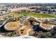 A large community playground with walking trails, bridges, a grassy field and covered picnic areas at 9230 E Scott Ave, Mesa, AZ 85212