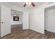 Bright bedroom with wood-look floors, a ceiling fan, and an ensuite entrance at 1047 W Laguna Dr, Tempe, AZ 85282