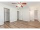 Bedroom with wood-look floors, a ceiling fan, closet and ensuite access at 1047 W Laguna Dr, Tempe, AZ 85282