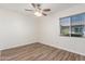 Inviting bedroom featuring wood-look flooring, a window and a ceiling fan at 1047 W Laguna Dr, Tempe, AZ 85282