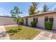 Inviting front yard with green lawn, mature landscaping, and a well-maintained facade at 1047 W Laguna Dr, Tempe, AZ 85282