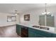 Open kitchen with stainless steel appliances, a breakfast bar, and modern lighting fixtures at 1047 W Laguna Dr, Tempe, AZ 85282