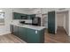 Stylish kitchen featuring quartz countertops, stainless appliances, and laminate floors at 1047 W Laguna Dr, Tempe, AZ 85282
