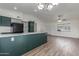 Contemporary kitchen with laminate floors, quartz countertops, and modern appliances at 1047 W Laguna Dr, Tempe, AZ 85282