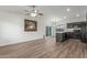 Open-concept living room with modern flooring, a ceiling fan, and a combined view of the kitchen at 1047 W Laguna Dr, Tempe, AZ 85282