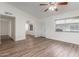 Bright living room showcasing laminate flooring, natural light from large windows, and a ceiling fan at 1047 W Laguna Dr, Tempe, AZ 85282