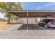 Assigned covered parking with black car at Laguna community at 1047 W Laguna Dr, Tempe, AZ 85282