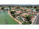 Aerial view of a lakeside home showcasing a private pool, lush landscaping, and community lake access at 11101 W Wilshire Dr, Avondale, AZ 85392