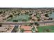 Breathtaking aerial view of a lake community showcasing homes with waterfront views and mature landscaping at 11101 W Wilshire Dr, Avondale, AZ 85392