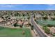 Stunning aerial view of a lake community featuring mature trees, lush landscaping, and tranquil water views at 11101 W Wilshire Dr, Avondale, AZ 85392