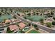 Gorgeous aerial view of lakeside homes featuring lush landscaping, a private pool, and serene water features at 11101 W Wilshire Dr, Avondale, AZ 85392