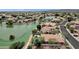 Scenic aerial view of waterfront homes highlighting lush landscaping, private pools, and tranquil lake views at 11101 W Wilshire Dr, Avondale, AZ 85392