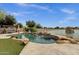 Backyard features a pool, hot tub, patio, and lake views; a perfect blend of luxury and nature at 11101 W Wilshire Dr, Avondale, AZ 85392
