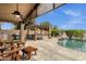 Outdoor patio featuring a pool, hot tub and a grill under a pergola and ceiling fan at 11101 W Wilshire Dr, Avondale, AZ 85392