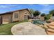 Exterior showcasing a backyard pool, spa, and verdant artificial turf, offering a resort-like experience at 11101 W Wilshire Dr, Avondale, AZ 85392