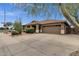 Exterior of a single story home featuring desert landscaping, a large driveway, and a two-car garage at 11101 W Wilshire Dr, Avondale, AZ 85392