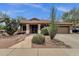 Charming single-story home featuring desert landscaping, a covered porch, and a two-car garage at 11101 W Wilshire Dr, Avondale, AZ 85392