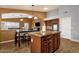 Kitchen island in a kitchen with a dining area with hanging pendant lights at 11101 W Wilshire Dr, Avondale, AZ 85392