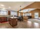 Open kitchen layout featuring an island, granite countertops, and seamless flow to the dining and living areas at 11101 W Wilshire Dr, Avondale, AZ 85392