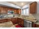 Kitchen with wooden cabinetry, stainless steel appliances and granite countertops at 11101 W Wilshire Dr, Avondale, AZ 85392