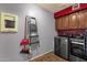 Brightly lit laundry room with washer and dryer hookups and storage cabinets at 11101 W Wilshire Dr, Avondale, AZ 85392