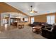 Spacious open-plan living room flows into kitchen with carpeted flooring and plush sofas at 11101 W Wilshire Dr, Avondale, AZ 85392