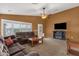 Cozy living room with plush sofas, carpeted flooring, ceiling fan and backyard views at 11101 W Wilshire Dr, Avondale, AZ 85392