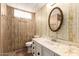 Well-lit bathroom features marble-look sink, vanity, and an oval mirror with a floral-patterned wallpaper at 11411 N 91St Ave # 28, Peoria, AZ 85345