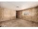 Empty bedroom featuring wood-paneled walls, neutral carpet, and a window at 11411 N 91St Ave # 28, Peoria, AZ 85345