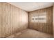 Bedroom with wood-paneled walls and a bright window at 11411 N 91St Ave # 28, Peoria, AZ 85345