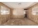 Spacious bedroom showcasing neutral carpet, wood-paneled walls, and natural light at 11411 N 91St Ave # 28, Peoria, AZ 85345