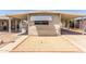 Charming single-story home with a covered carport and front gravel yard at 11411 N 91St Ave # 28, Peoria, AZ 85345