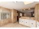 View of kitchen with white cabinets and sink, open to living area with light and bright interior at 11411 N 91St Ave # 28, Peoria, AZ 85345