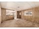 View of the living room with wood-paneled walls and neutral carpet at 11411 N 91St Ave # 28, Peoria, AZ 85345