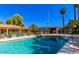 Community pool with lounge chairs and clear blue water at 11411 N 91St Ave # 28, Peoria, AZ 85345