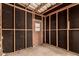 Interior view of an unfinished storage area with wooden framing and a door at 11411 N 91St Ave # 28, Peoria, AZ 85345