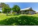 A home featuring a lush green lawn with mature trees and meticulously maintained shrubs at 12719 W Ashwood Dr, Sun City West, AZ 85375