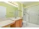 This bathroom has a white shower and toilet, and a wood vanity at 12719 W Ashwood Dr, Sun City West, AZ 85375