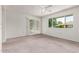 Bright bedroom with sliding door access to the yard, complemented by a ceiling fan for added comfort at 12719 W Ashwood Dr, Sun City West, AZ 85375