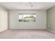 Bright bedroom featuring neutral carpet, a window with natural light, and a ceiling fan at 12719 W Ashwood Dr, Sun City West, AZ 85375