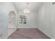 Formal dining room with chandelier, window with shutters, and plush carpet at 12719 W Ashwood Dr, Sun City West, AZ 85375