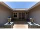 Inviting front porch featuring decorative lanterns, a secure gated entry, and a charming view of the home's facade at 12719 W Ashwood Dr, Sun City West, AZ 85375