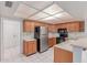 Functional kitchen featuring wooden cabinetry, white countertops, and stainless steel appliances for a modern touch at 12719 W Ashwood Dr, Sun City West, AZ 85375
