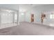 Open-concept living room with vaulted ceiling, chandelier, neutral paint, with both carpet and tile flooring at 12719 W Ashwood Dr, Sun City West, AZ 85375