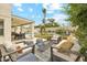 Expansive backyard showcasing an outdoor dining area, seating area, in-ground pool, and lush landscaping at 1285 E Horseshoe Ave, Gilbert, AZ 85296