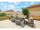 Cozy backyard featuring an outdoor seating area, fire pit, and manicured landscaping at 1285 E Horseshoe Ave, Gilbert, AZ 85296